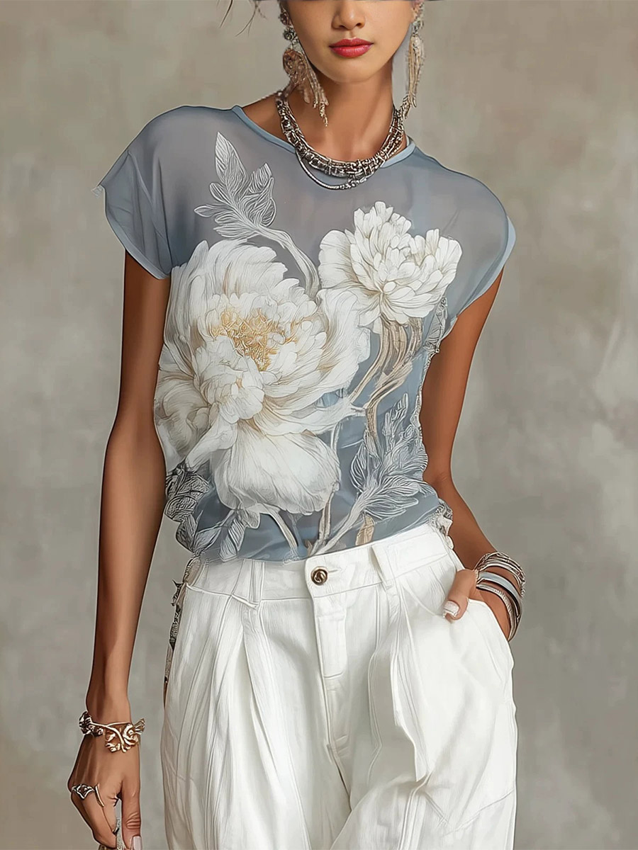 Blouse transparente à manches courtes et imprimé floral style aquarelle vintage en mousseline ample.
