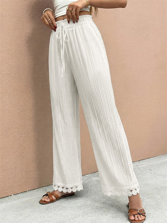 Pantalon large à ourlet en dentelle blanche et cordon de serrage coupe ample et décontractée idéal pour l'été.
