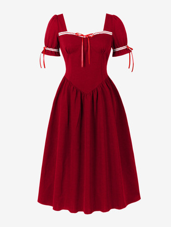 Robe vintage pour femme manches bouffantes coupe midi col carré nœud sur le devant évasée.