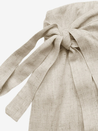Jupe-short portefeuille en lin pour femme couleur abricot clair à nouer sur le côté style décontracté idéale pour l'été.