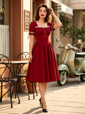 Robe vintage pour femme manches bouffantes coupe midi col carré nœud sur le devant évasée.